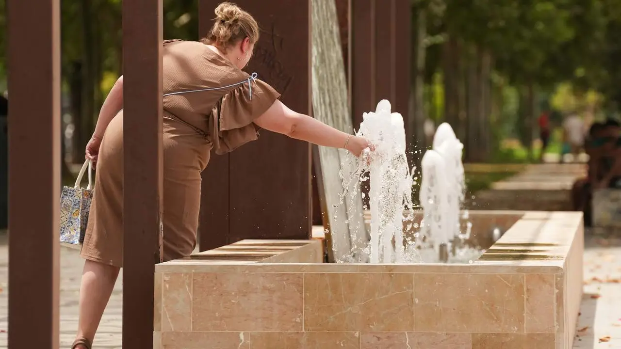  Una mujer se refresca en una fuente, en foto de recurso | E.P. 